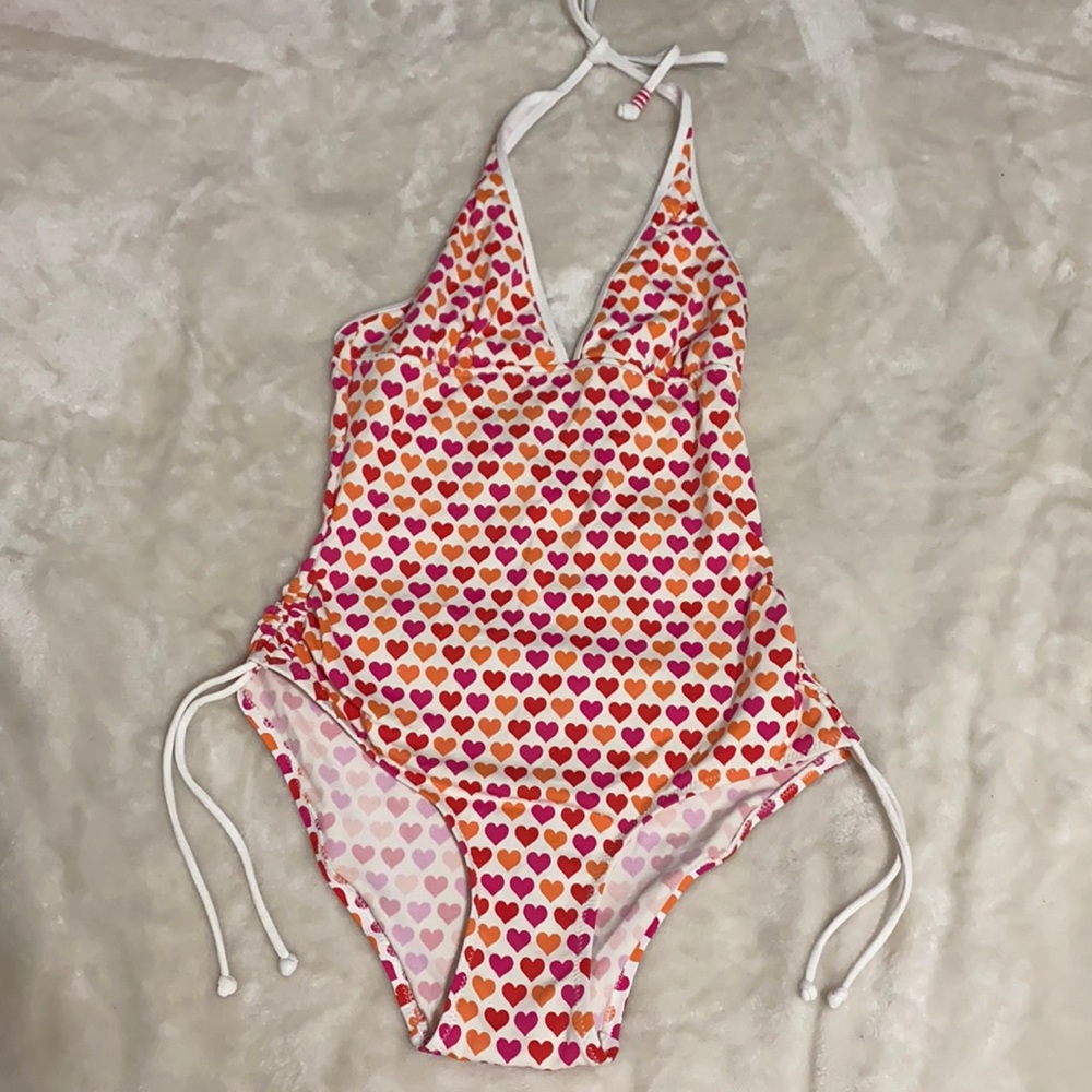 One piece bathing suit covered in hearts